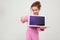 Contented caucasian girl holding a laptop with the screen forward with the layout for the page on a white background