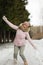 A contented Caucasian woman walks in a winter park. Young woman against a snow-covered park on a sunny day