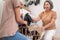 Contented daughter and mother in the household washing room working together.