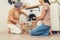 Contented daughter and mother in the household washing room working together.