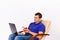 A contented deaf senior man holding a hearing aid and a red heart in front of a laptop camera. Online Charity on white