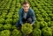 Contented Farmer Lad Holding Lettuce On Field