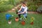 Contented female gardener planting flowers in pots