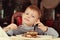 Contented little boy eating cake for dessert