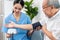 A contented retired man having a blood pressure check by his personal caregiver.