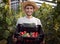 Contented Young Farmer Posing Tomatoes and Cucumbers