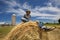 Contented Young Farmer on Round Bale