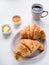 Continental breakfast with French croissants, butter, jam and bl