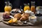 Continental breakfast served over wooden table with croissants, fruits, yoghurt, tea, butter and fresh juice