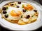 Continental breakfast - sunny side up eggs with onion and parmesan on wooden background