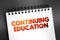 Continuing Education - term within a broad list of post-secondary learning activities and programs, text on notepad, concept