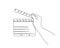 Continuous line drawing of hand holding movie clapboard. cinema clapperboard illustration with editable stroke