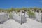 Continuous Lines of Beach Fence, with Beach Grass and Blue Sky