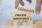 Continuous process improvement text on wooden blocks. Continuous improvement concept.