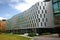 Continuous and undulating gray facade of Vicki Sara Building with array of rectangular windows at University Technology Sydney UTS