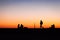 Contours of people and yacht with a big sail on the sea as background, night