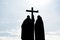 Contours of two Orthodox monks with a cross