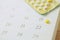 Contraceptive control pills on date of calendar background.