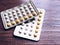 Contraceptive pill panel, birth control pills on wooden table