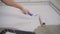Contract painter painting garage floor to speed up selling of home. Paint the floor with a roller