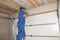 Contractor Installing Garage Door Opener. Garage door springs, garage door replacement, garage door repair.