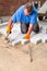 Contractor laying paving stones on a building site.