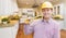 Contractor with Level Wearing Hard Hat Standing In Custom Kitchen