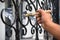 Contractor`s hand with brush that painting metal fence.