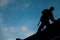 Contractor in Silhouette working on a Roof Top