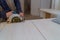 Contractor uses a saw to cut through a laminate kitchen formica counter top. Focus on saw