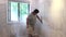 Contractor using sand trowel sanding the drywall
