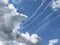 Contrails of aircraft and giants cumulonimbus clouds in the blue sky