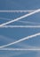 Contrails cut across the sky in a perfect double Z pattern as air travel resumes