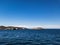 Contrast beautiful scene with green island between bay of sea and blue sky