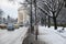 Contrast between a cleared auto road and a snow covered sidewalk with a narrow footpath made by pedestrians, in Winter, in Romania