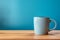 Contrast: Coffee mug on wood table against calming blue background