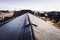 Contrast of frost line on a shingle roof as the sun rises and melts it