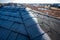 Contrast of frost line on a shingle roof as the sun rises and melts it