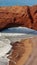 Contrast of giant stone arch and small person