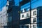 Contrast of modern and old buildings reflected in large modern glass windows with lines in perspective