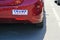 Contrasting bumper sticker Trump Pence on red car