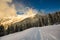 Contrasts of sunset lights in winter landscape by snow in the mountains