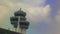 Control Tower Radar by Airport Terminal Building against Sky