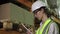 Controller girl in safety helmet and vest during factory inspection