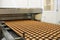 Controlling the work of huge conveyor machine producing spice cakes at the confectionary plant. Cookie production line. Innovative