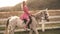 Contryside woman ride on horse. Girl walking on ranch with horses.