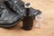Convenient liquid shoe polish with worn out shoes on wooden plat