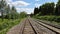 Converging Railway tracks passing under a bridge