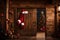 Convey the anticipation of Santa\\\'s arrival with a visual of Santa\\\'s costume hanging on a wooden door.