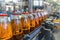 Conveyor belt, juice in bottles on beverage plant or factory interior, industrial production line, selective focus